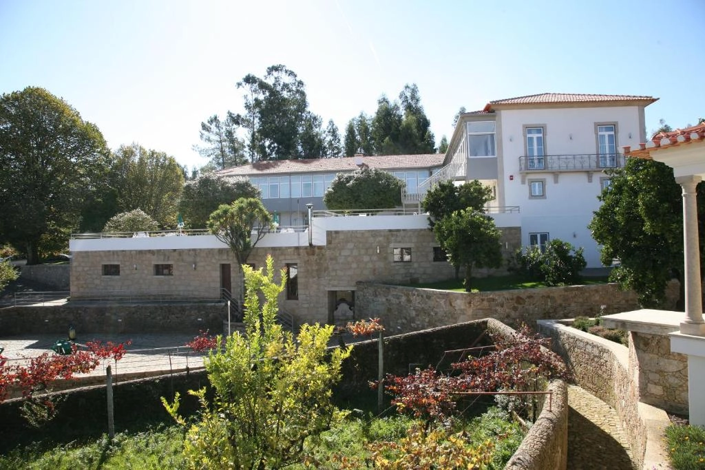 View of Hotel Quinta Progresso surrounded by gardens and northern Portugal countryside